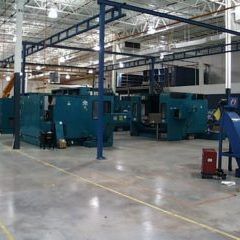 Large machines under overhead steel on a plant floor