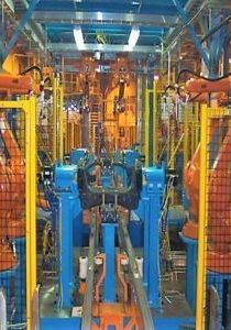 Robotic welding cell inside a manufacturing plant