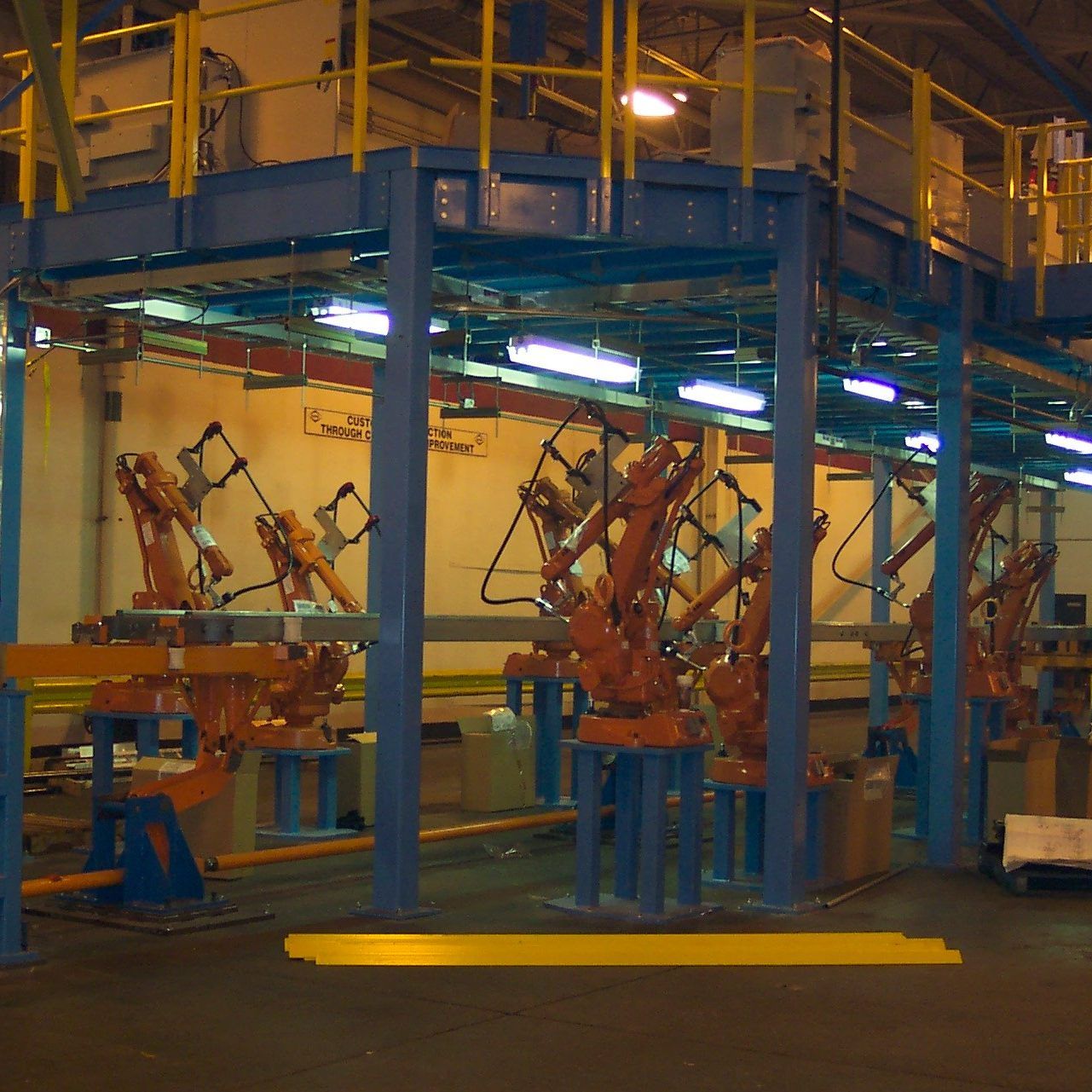 Industrial robots under an elevated steel platform